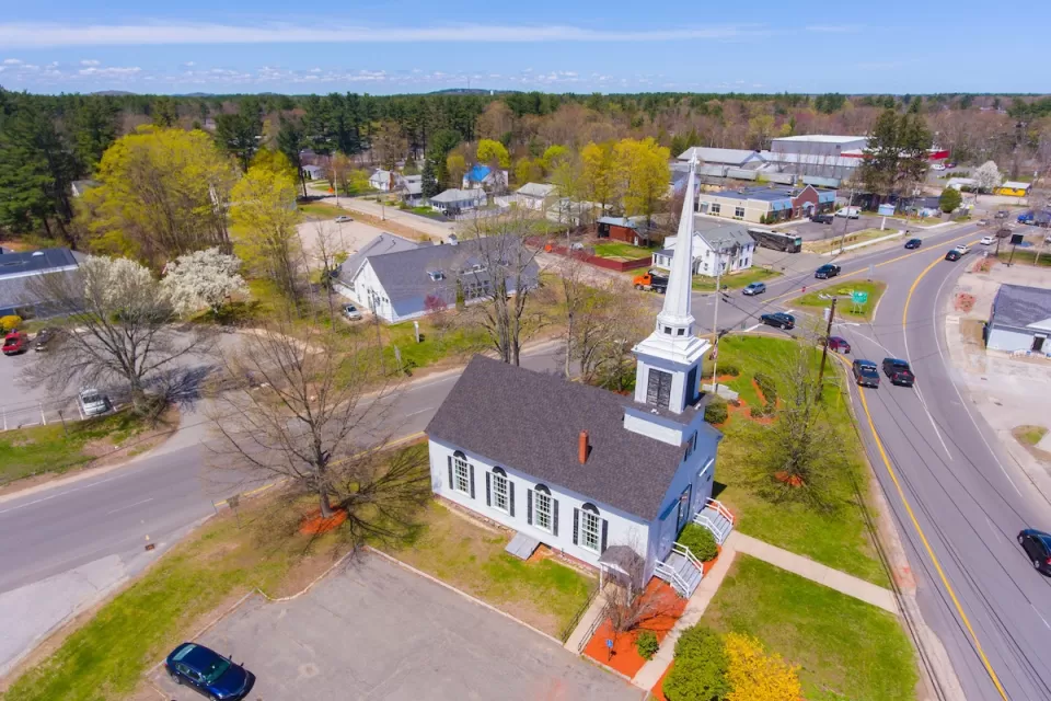 Aerial view of Trinity United Church aerial view at 103 Lafayette Road at Main Street in Seabrook historic town center, New Hampshire NH, USA.